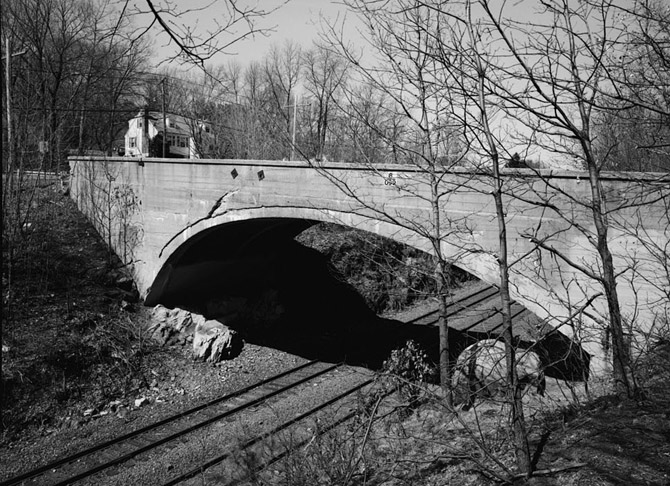 Cooper Street Bridge is significant as a very early example of reinforced concrete arch construction, notable for its substantial size, asymmetrical profile, and use of an unusual type of deformed rod for reinforcement. It is one of only two concrete-arch bridges of its age spanning more than 50' that are known to survive in Massachusetts. Although the designer of the bridge is unknown, the contractor, Joseph Ross, was one of Boston's leading builders of wharves and bridges.