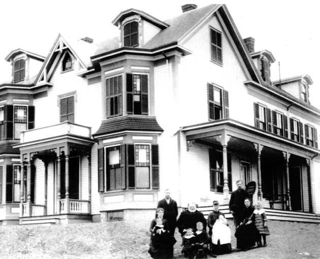 The Perley family and farmhouse at 387 Linebrook Rd. This picture is believed to have been taken in 1888. Standing: David Sydney Perley (2-21-1862) Seated in front: Louise Hart Perley (9-5-1865) On her lap: Marion Perley Jenks (1-7-1888) Seated: David Tuller Perley (1-17-1824) Seated in front: Bertha Perley Moulton (10-18-1886) Chester Garfield Perley (11-13-1881) Seated next to David T. Perley: Elizabeth Lavalette Perley (2-15-1857) On her lap: Harrison Otis Perley ( 9-30-1888) Standing: Roscoe Damon Perley (8-11-1864) Seated: Carrie Sophronia Perley (10-18-1865) Standing: Mabel Perley Charlton( 8-19-1883)
