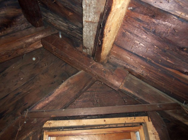 Attic framing shows where the roof was raised when the lean-to was added