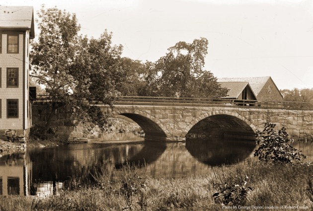 The County St. Bridge. William J. Barton wrote, "In December, 1860, Ira Worcester and others of Ipswich, Hamilton, Wenham and Essex addressed a petition to the County commissioners. At that time, Cross Street as it was called, terminated at Green Street (the present day County Street) and all travel towards Hamilton passed  over Town Hill , down the hill and over the Choate Bridge. The petitioners characterized this route as very circuitous and hilly, and inconvenient. The County Commissioners laid out the new road on March 5, 1861. The town voted on March 11 to build the bridge. The County Street stone arch bridge was built in 1861 by the town at a cost of $7896.75. Thomas J. Roberts, an Ipswich citizen who was a master builder on the Boston City Hall, the Thatcher Island Lighthouse etc. was the superintendent." Photo by George Dexter.