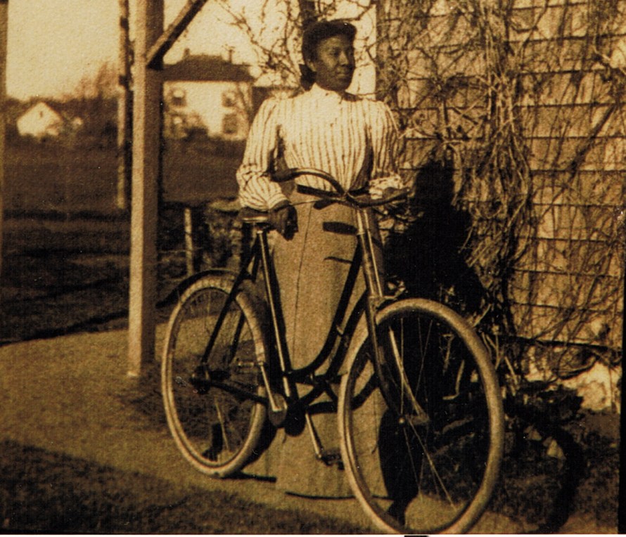 Emma Safford with her bicycle at the Safford home on Green St.