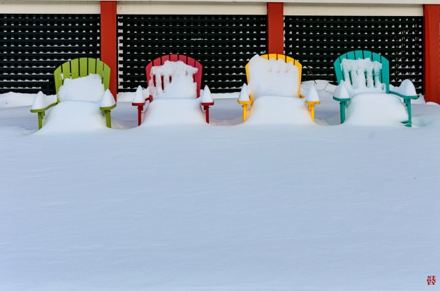 Chairs covered by snow